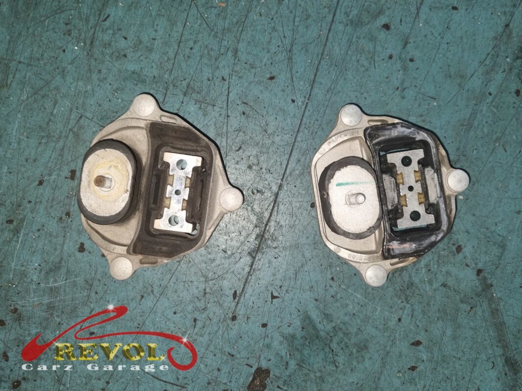 An old engine mount (left, rubber worn and the bore enlarged) next to its new VAG-spec replacement (right, rubber tight).