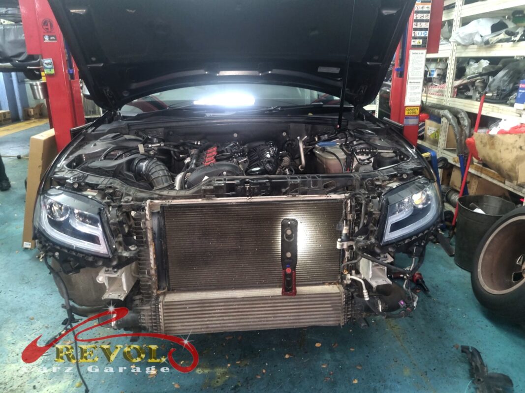 The front of the A4 with the bumper off, the condenser, radiator and intercooler stacked up at the front of the bay.