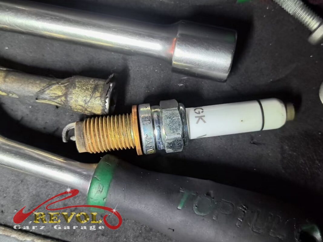 One of the old spark plugs pulled for a look, the threads discoloured and worn.