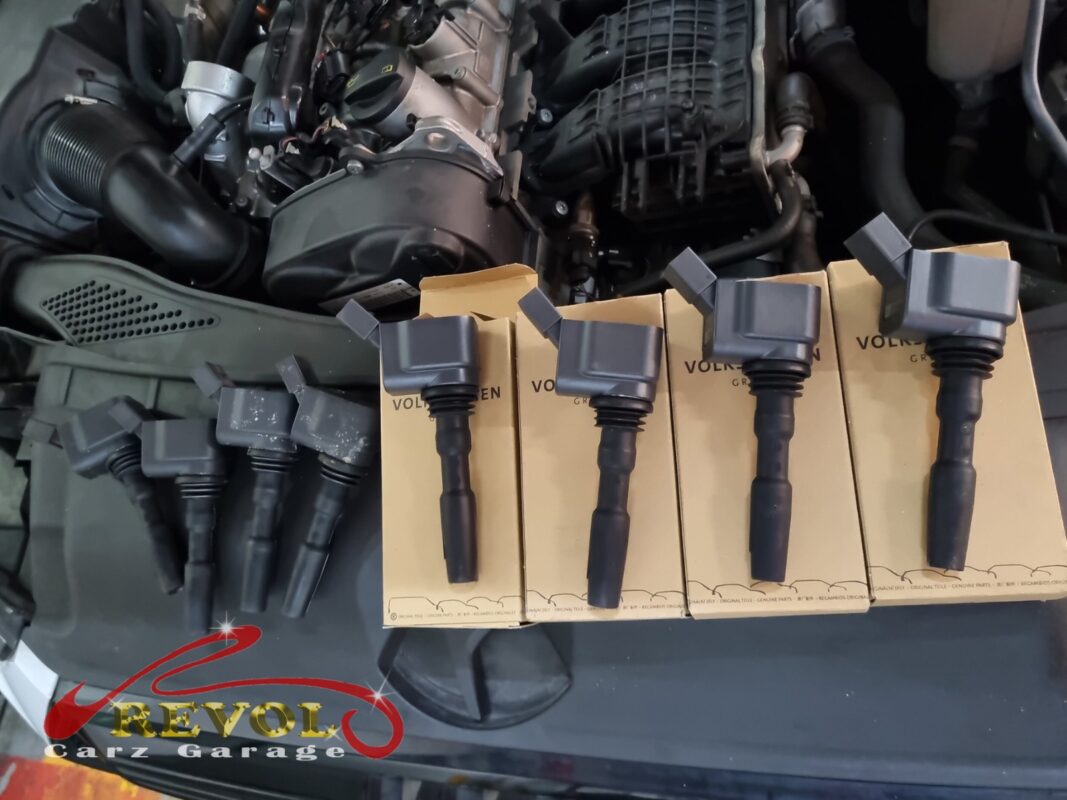 The four old ignition coils (left) next to the four new VAG-spec replacements (right), still on their boxes.