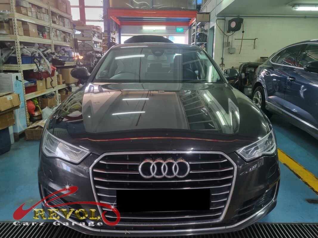 Audi A6 in the workshop for combined spark plug and ignition coil service.
