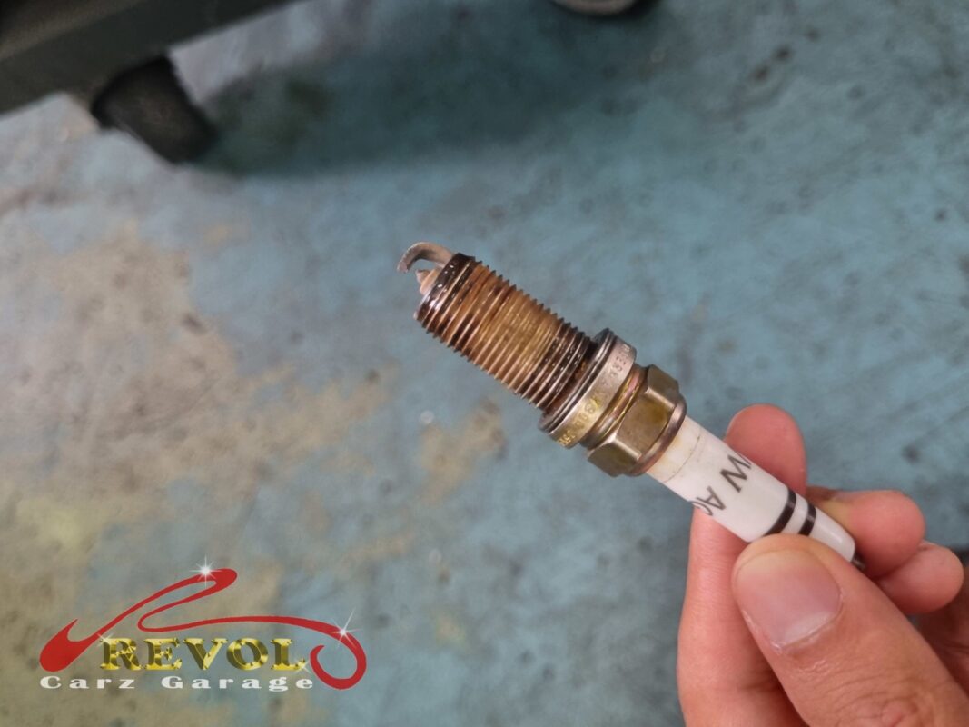 An old spark plug pulled for inspection, the electrode wear about what you would expect for the mileage.