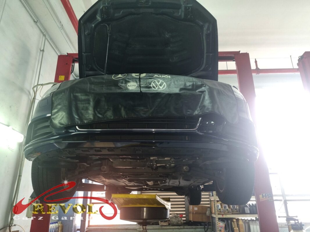 The Audi A3 up on the two-post lift, fender cover on, in for its scheduled service.