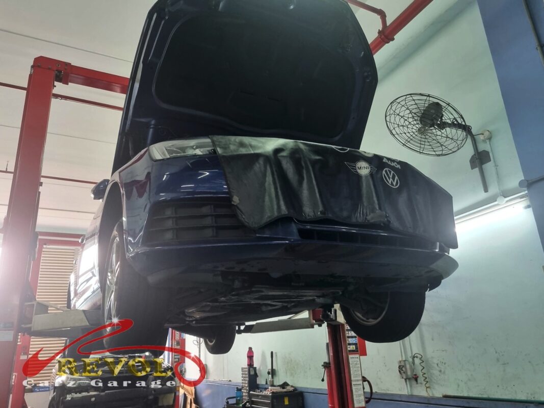 The Audi A4 up on the two-post lift, fender cover on, in for the scheduled belt change.