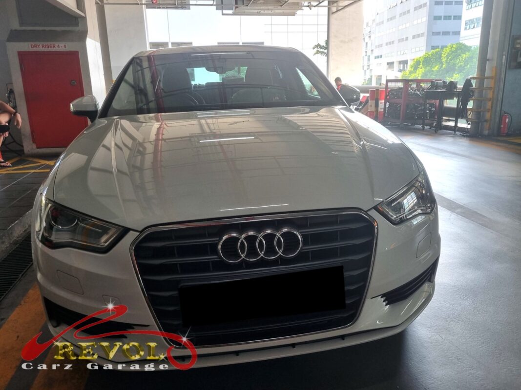 Audi A3 on the workshop lift with the rear wheel off for bearing diagnosis.
