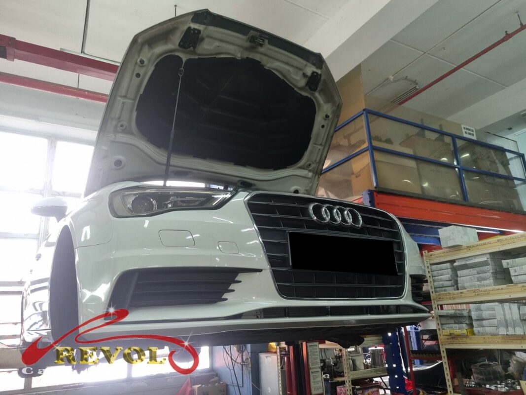 The white Audi A3 up on the two-post lift, in to track down the hum from the back.