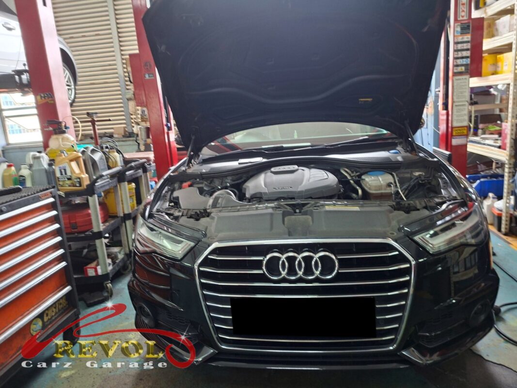 Audi A6 on the workshop lift for oil sump replacement.