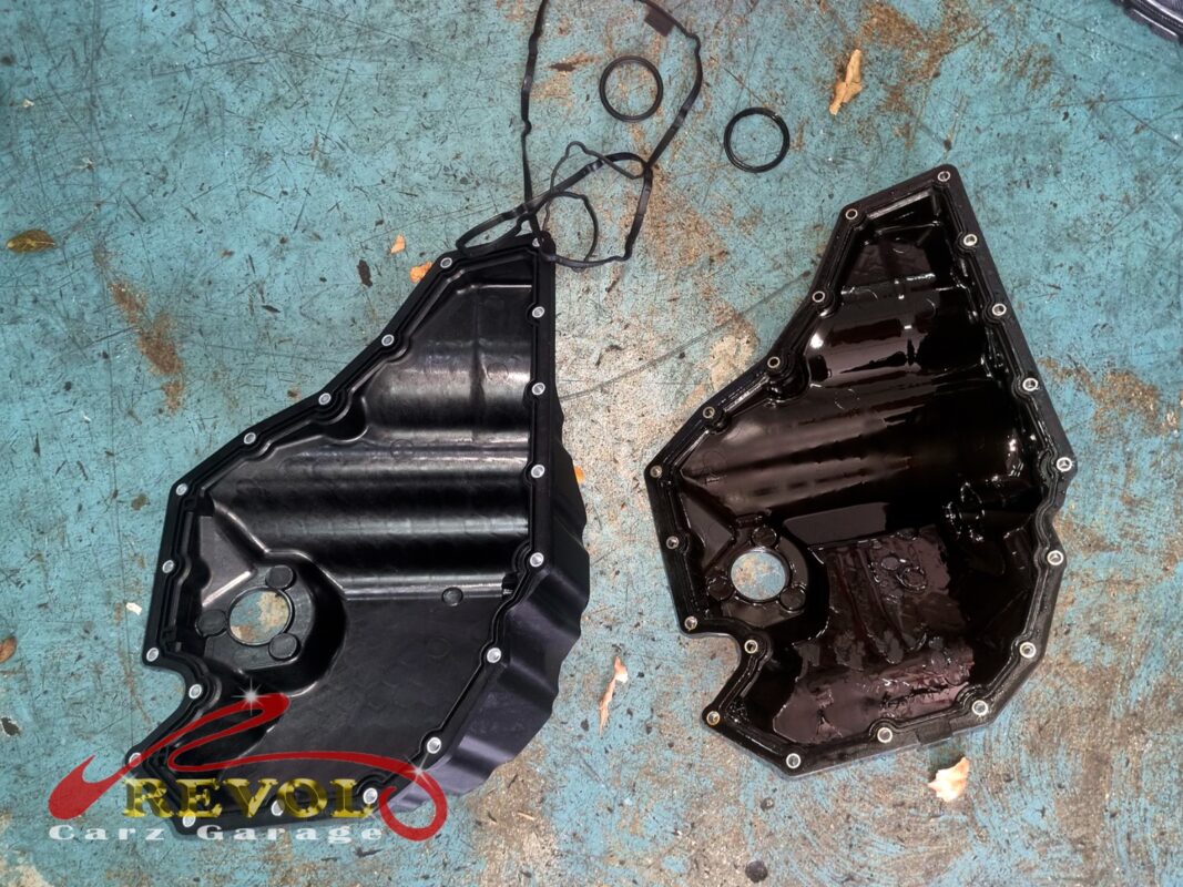The old oil sump pan (left, old gasket draped over it) next to the new VAG-spec replacement (right), with a fresh gasket and seals.