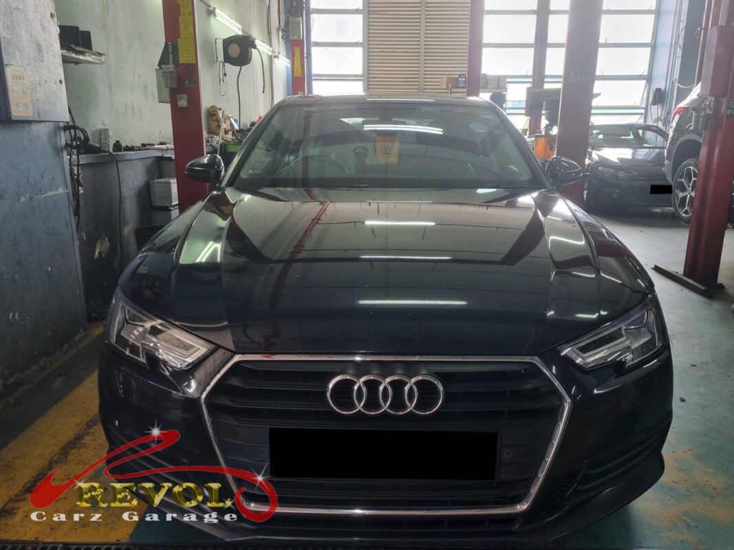 Audi A4 on the workshop lift for oil leak diagnosis.