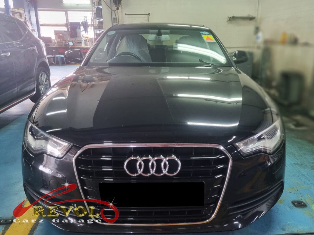 Audi A6 with the engine cover off for oil-gas separator replacement.