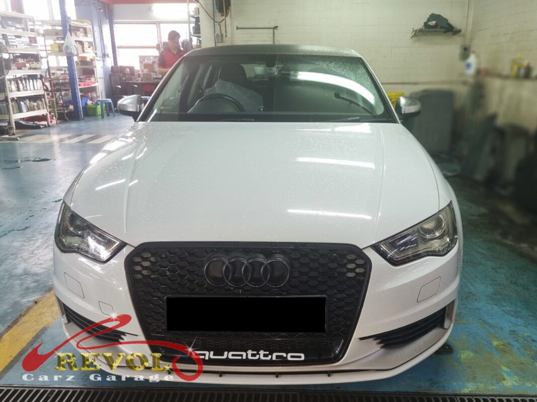 Audi A3 with the front of the engine open for timing belt set replacement.