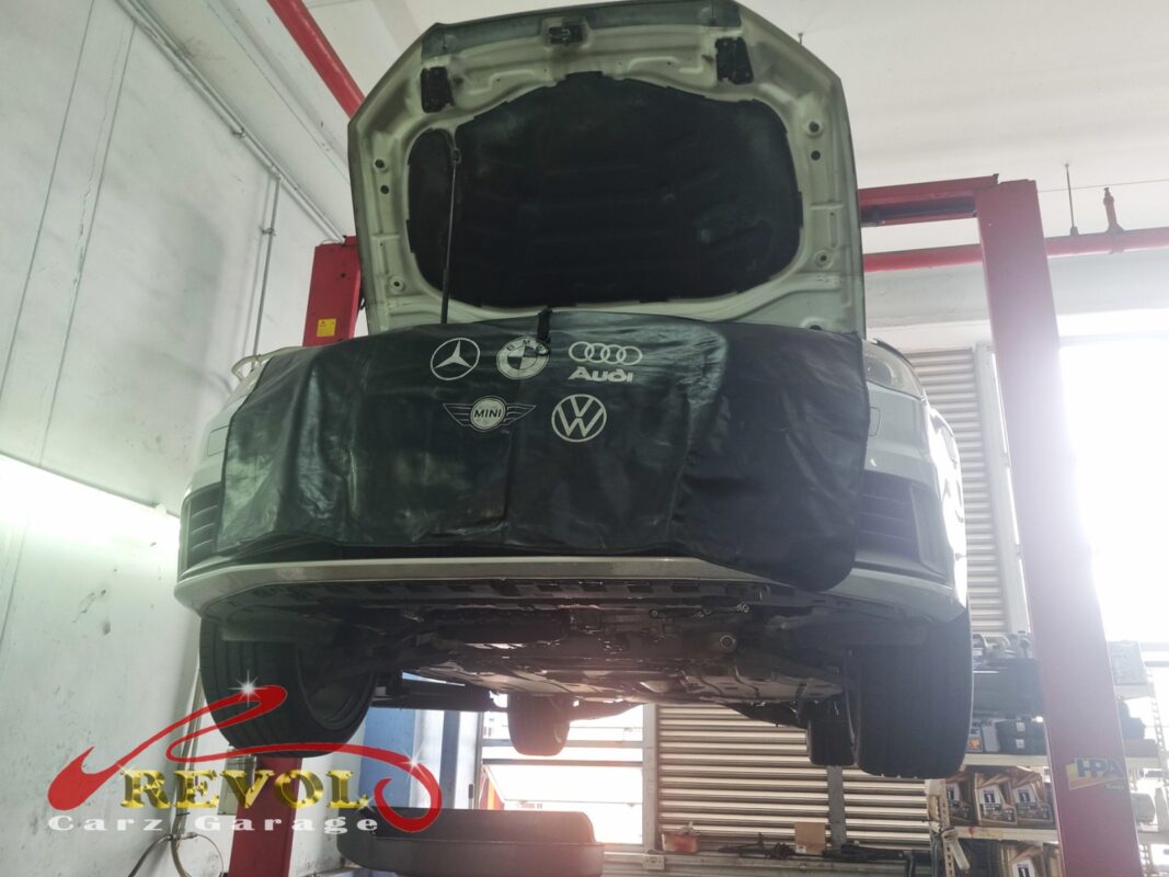 The Audi A3 up on the two-post lift, fender cover on, in for the scheduled timing belt service.