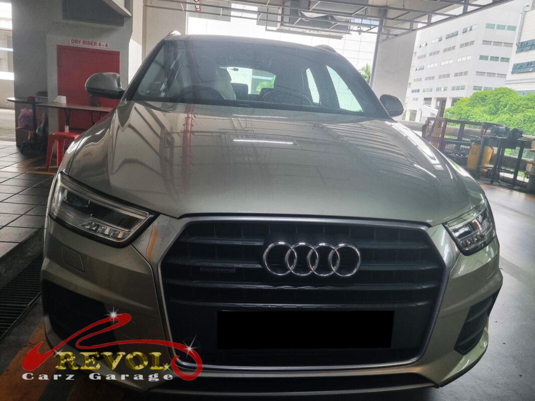 Audi Q3 with the front bumper removed for radiator fan replacement.