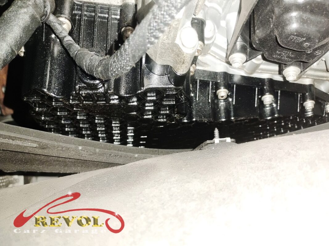 The transmission area from below, the ATF pan and the surrounding metal wet where the gasket had been weeping.