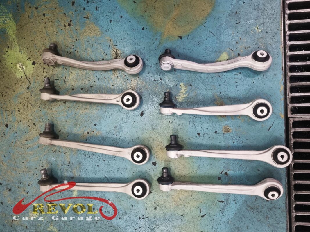The full set of new Audi-spec front control arms before fitting. On this multilink front end the arms wear together, so all of them went in rather than just the worst pair.