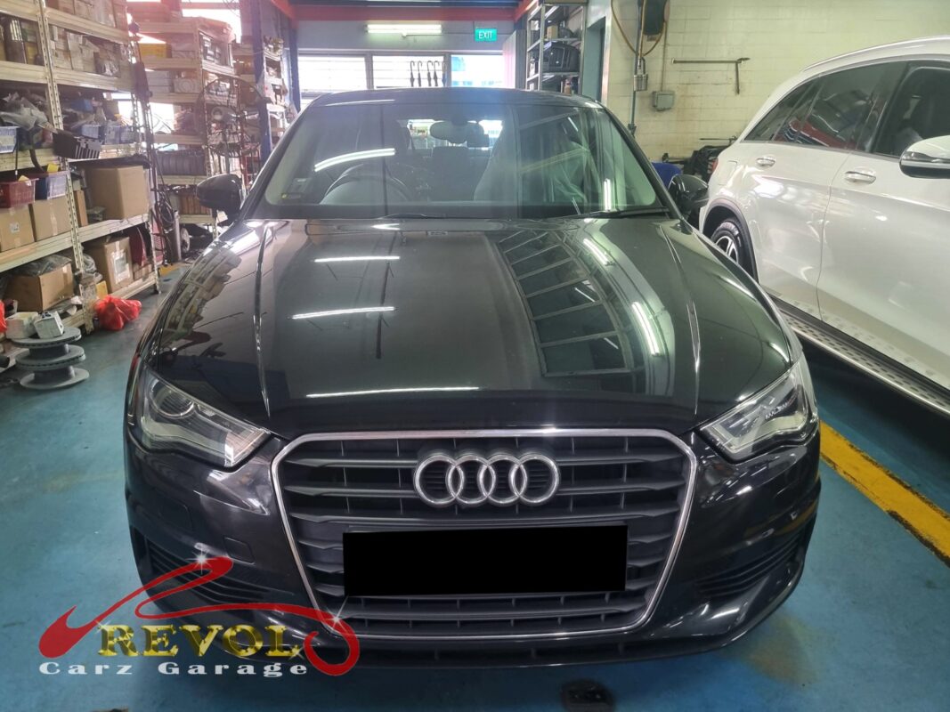 Audi A3 on the workshop lift with the front wheel off for bearing diagnosis.