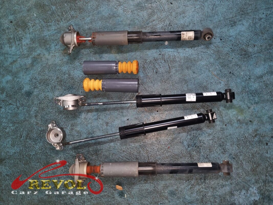 The old rear shocks (top and bottom) next to the new Audi-spec pair (centre), with fresh bump stops, boots and top mounts.