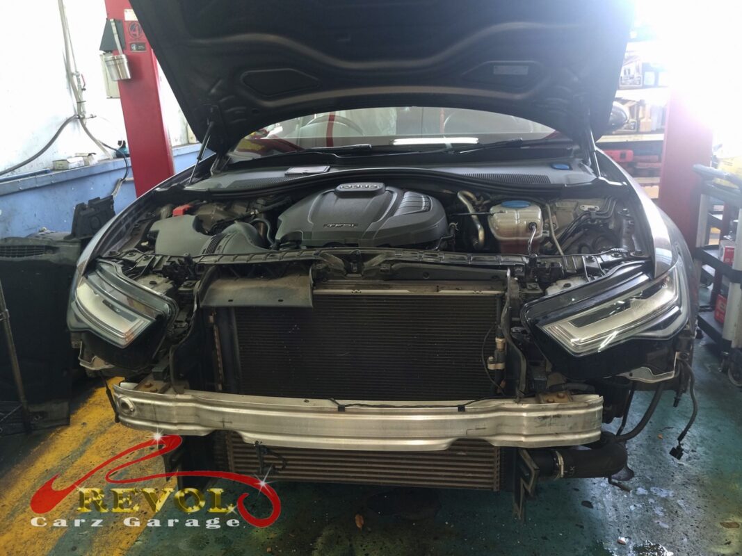 The front of the A6 with the bumper off, the radiator exposed and the fan shroud accessible behind it.