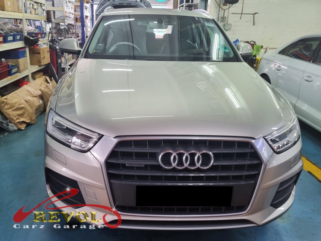 Audi Q3 on the workshop lift for front lower control arm replacement.