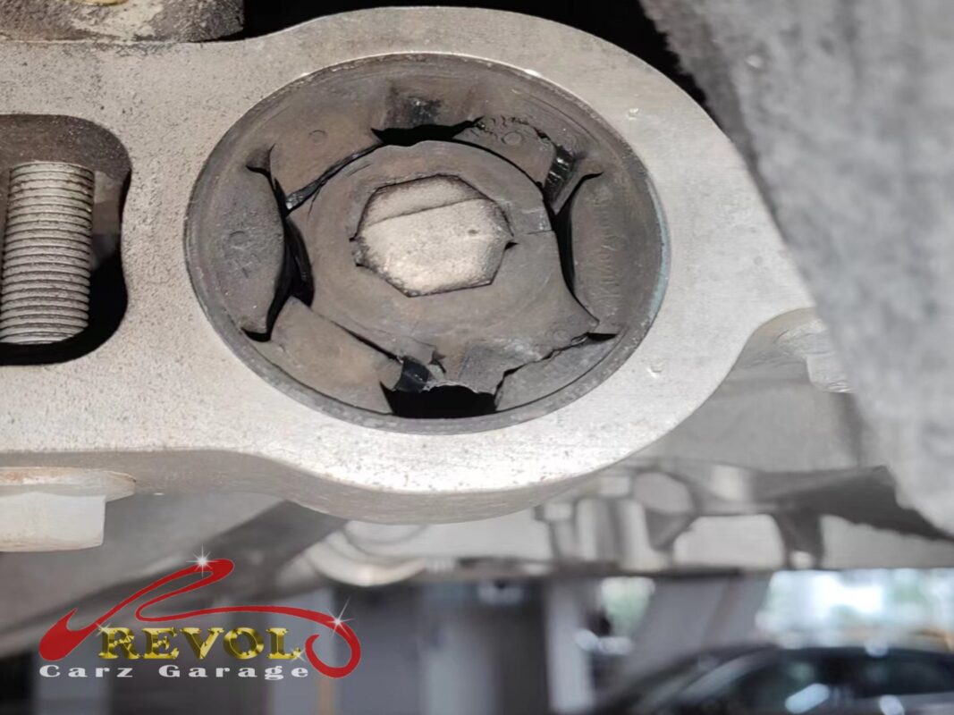 A lower control arm bushing, the rubber split and torn right through, well past any service spec.
