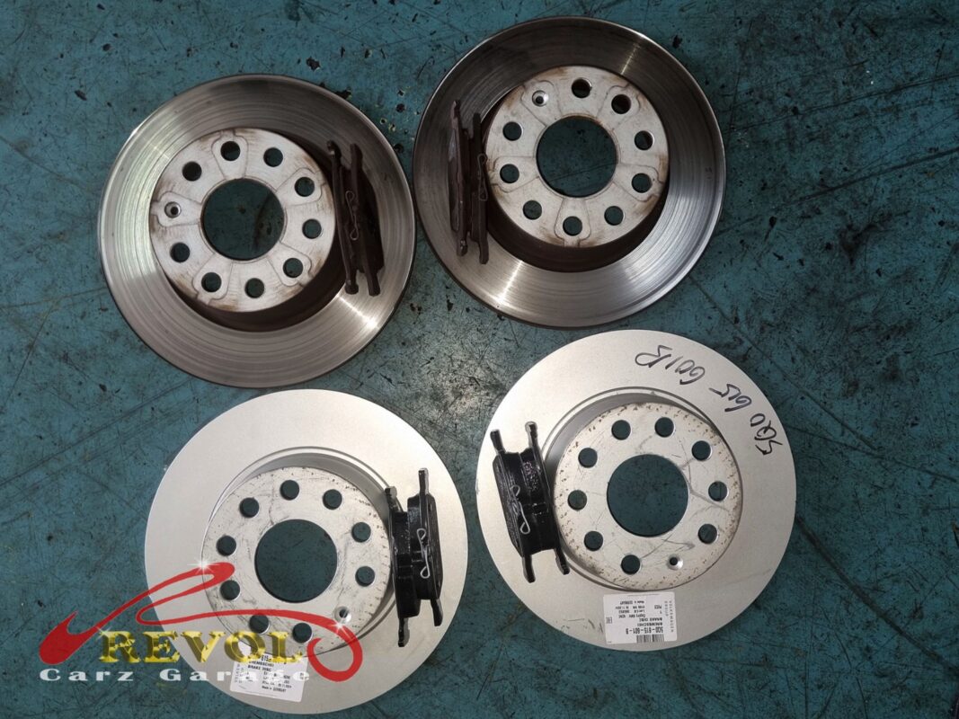 The two old front discs with their worn pads (top) next to the two new Audi-spec discs and fresh pads (bottom).