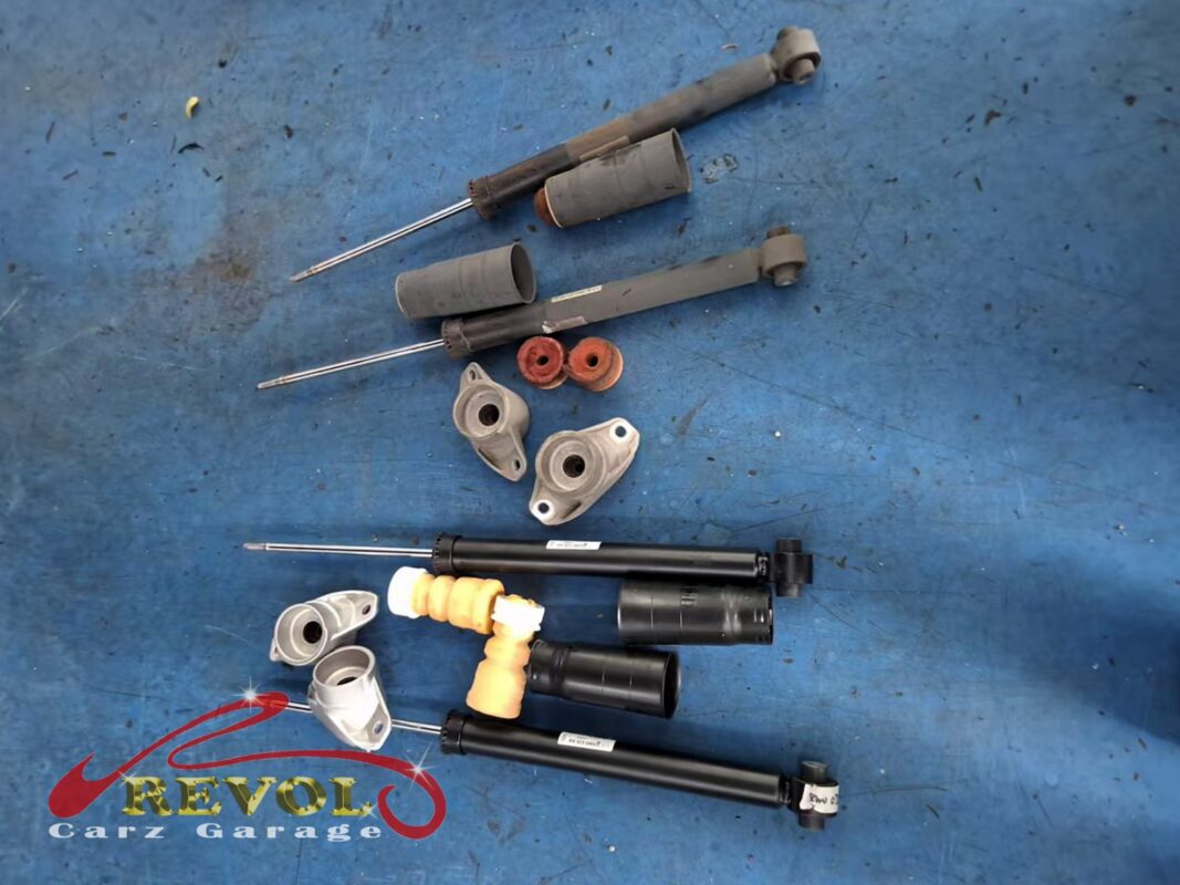 The old rear shocks (top, with their boots and mounts) next to the new Audi-spec pair (bottom), with fresh bump stops, boots and top mounts.