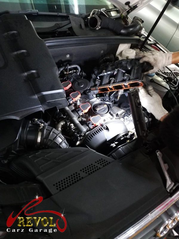 The old intake manifold removed from the engine.