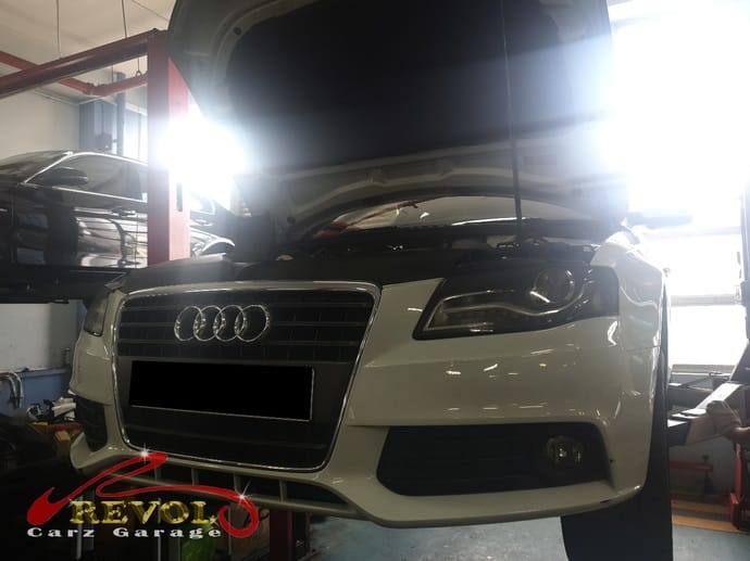 The Audi A4 lifted for a visual inspection of the air compressor area.