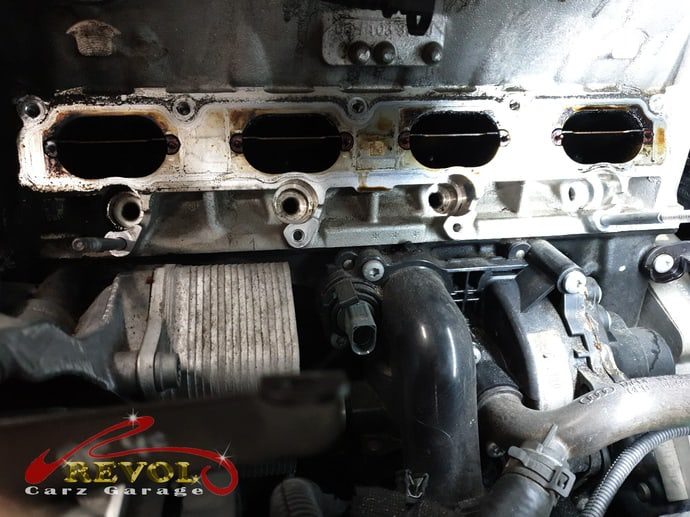 The repair beginning, the intake manifold being removed to reach the sensor.