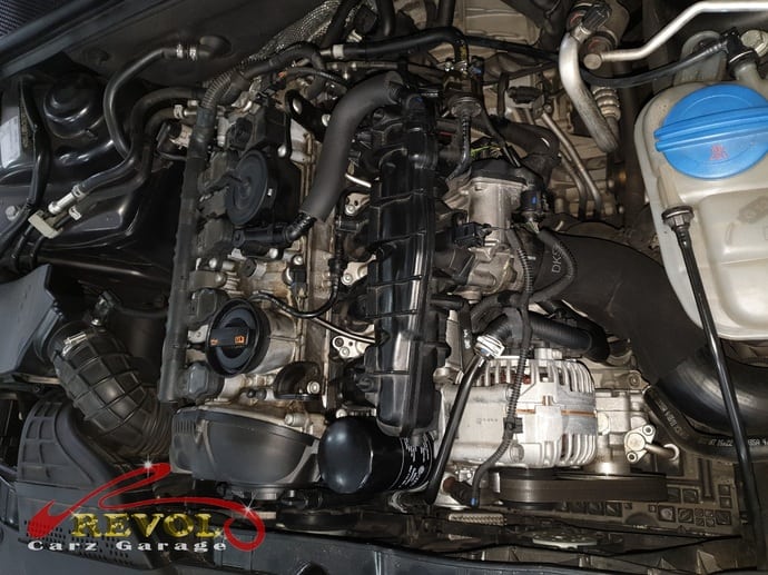 The Audi technicians at work fitting the new intake manifold position sensor.