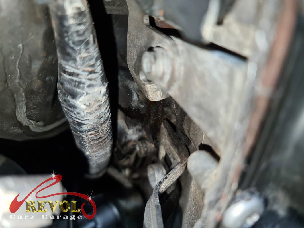 The old water pump and thermostat module removed showing the weeping seal.