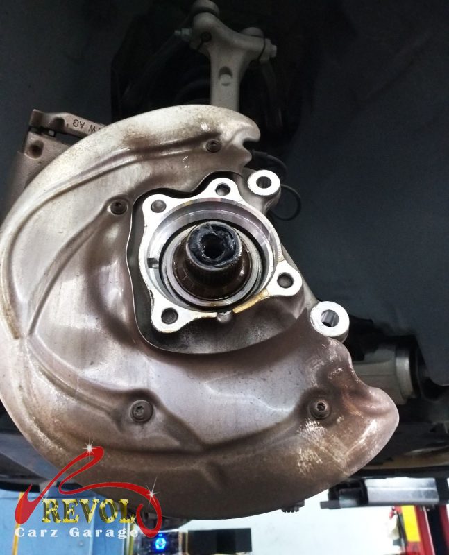 The corner stripped down to the worn wheel bearing.