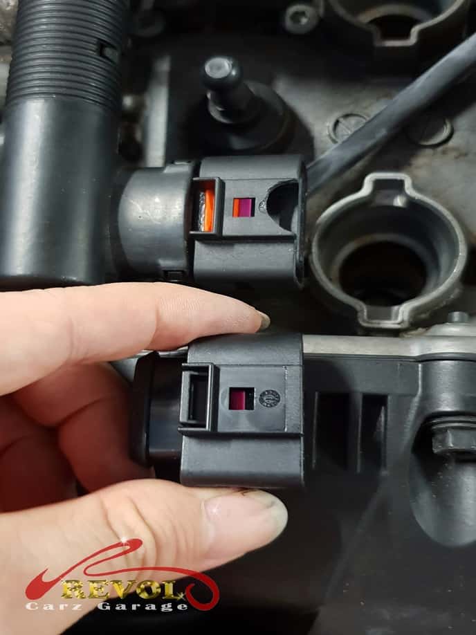 The old ignition coils removed, the plastic sockets brittle from the heat.
