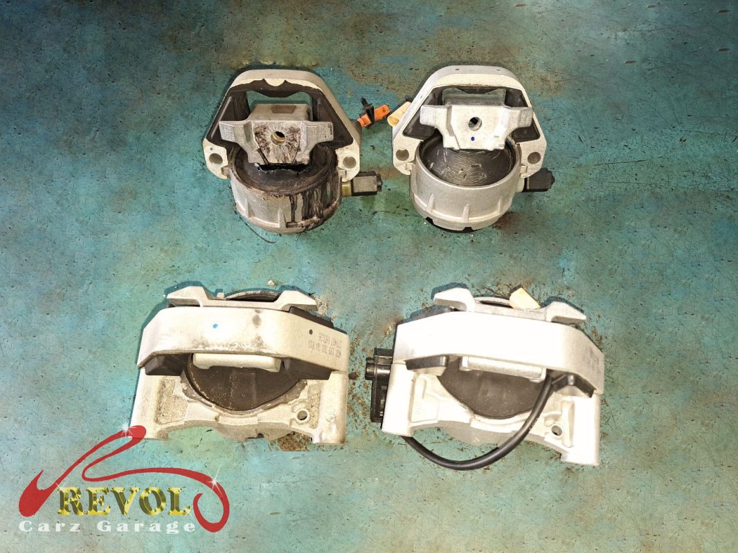 The transmission mount removed showing the play under load.