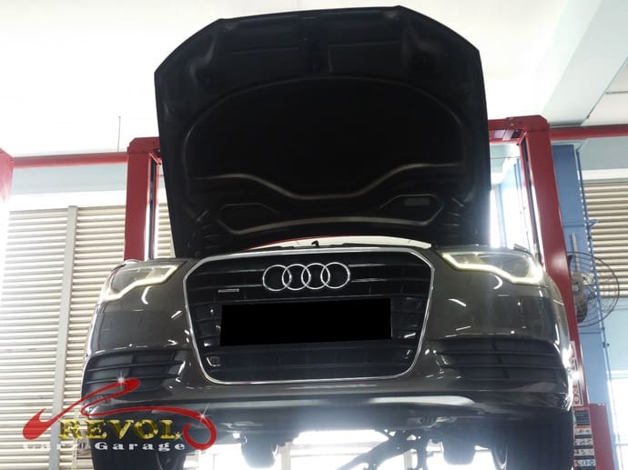 The Audi A6 lifted to check for any transmission oil leak.