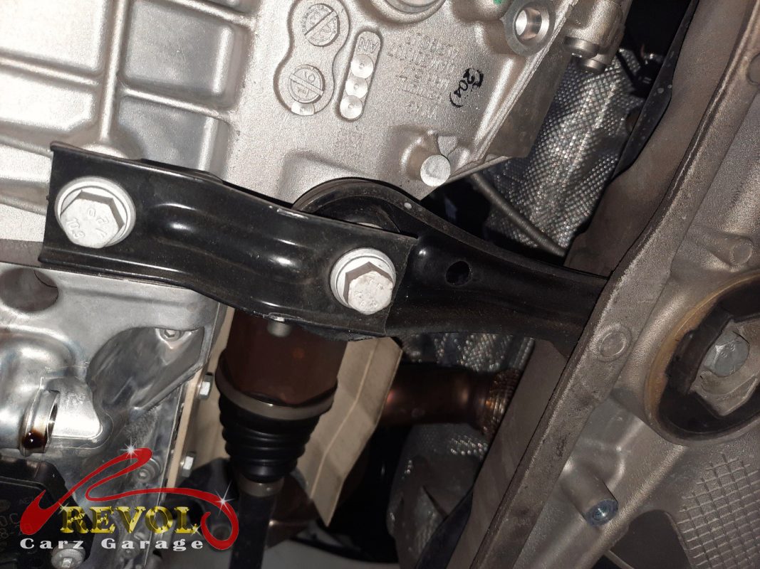 The transmission mount removed showing the play under load.