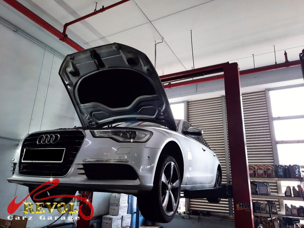 The worn engine mount with cracked and sunken rubber on the Audi A6.