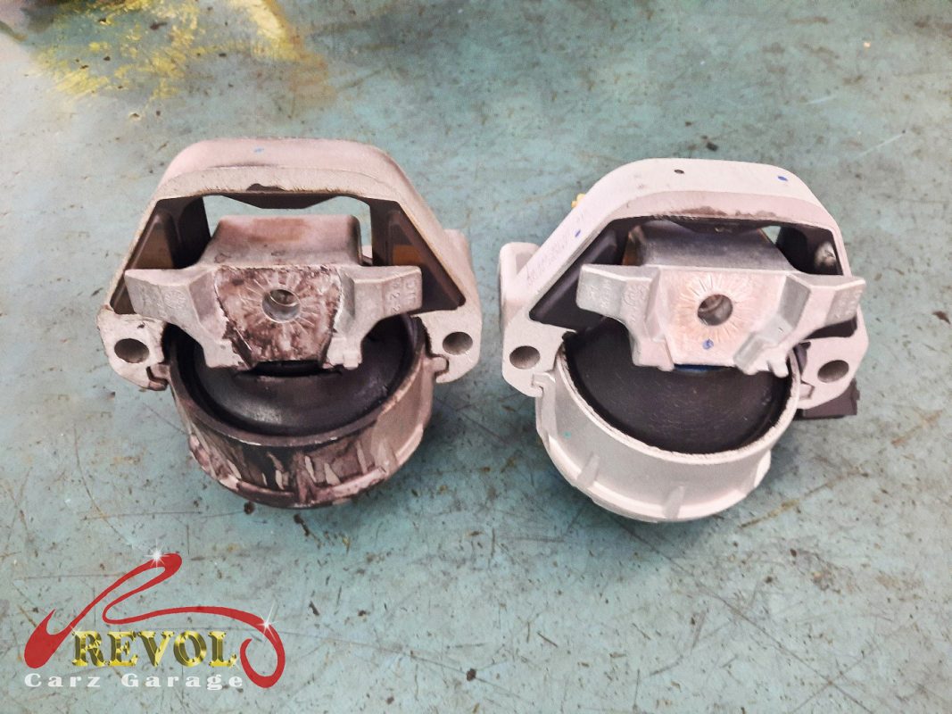 The transmission mount removed showing the play under load.