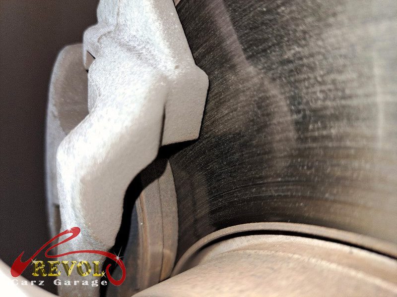The worn front pads and scored disc on the Audi A3.