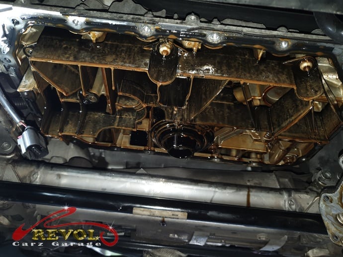 The failed oil cooler identified as the source of the contamination.