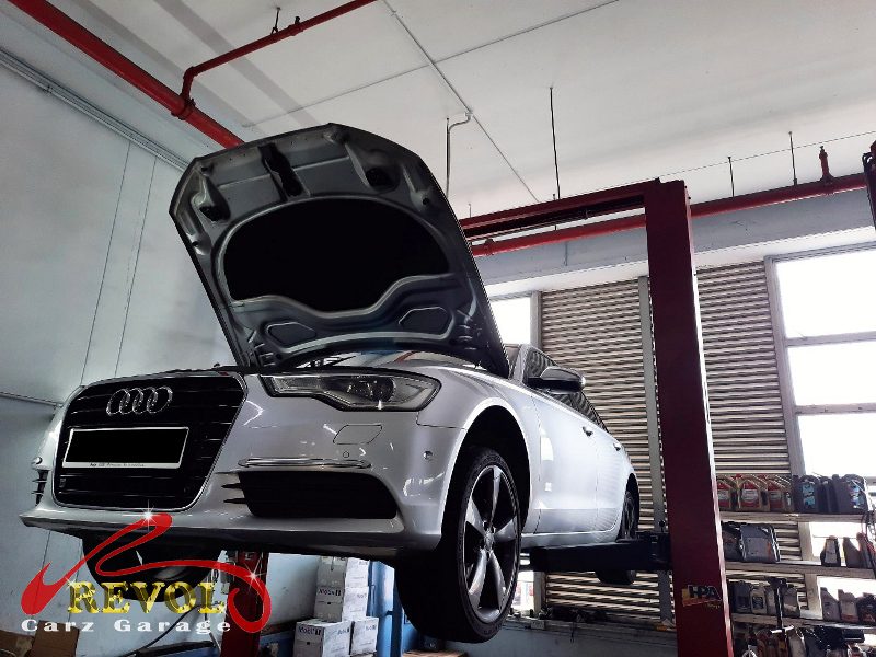 The worn engine mount with cracked and sunken rubber on the Audi A6.