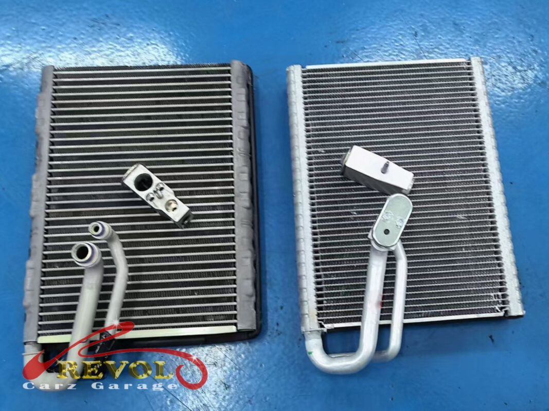 The old evaporator core (left) next to the new Audi-spec replacement (right), each with its expansion valve.