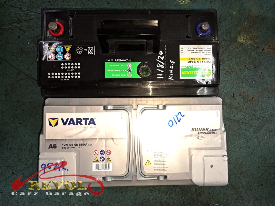 Failed battery lifted out, terminal corrosion visible.