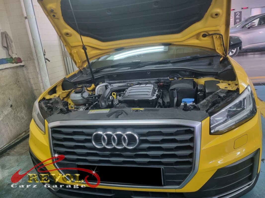Audi Q2 on the workshop lift with the front subframe partially dropped for bushing replacement.