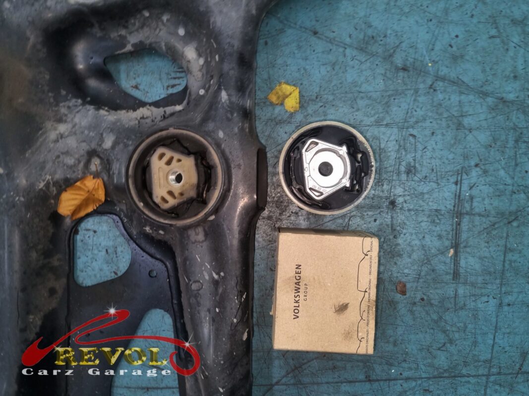 The old subframe bushing in its seat (left) next to the new VAG-spec replacement (right), out of its box and ready to press in.