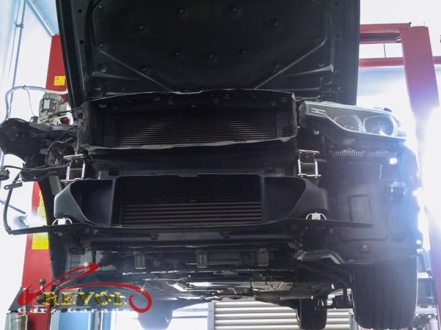 The BMW 320i accident damage to the right headlight, bumper and fender.