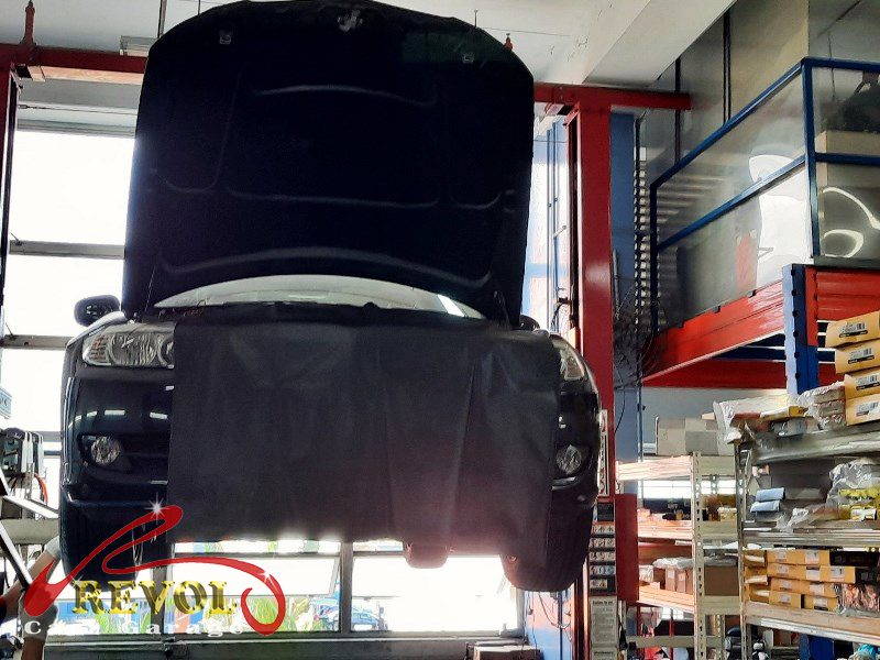 The worn shock absorbers on the BMW 318i, weeping and weak.