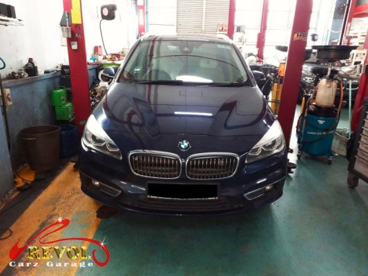 BMW 216d parked at the workshop, in for shock absorber inspection.
