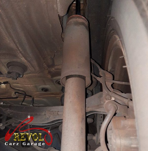The old rear shocks removed alongside the new pair.