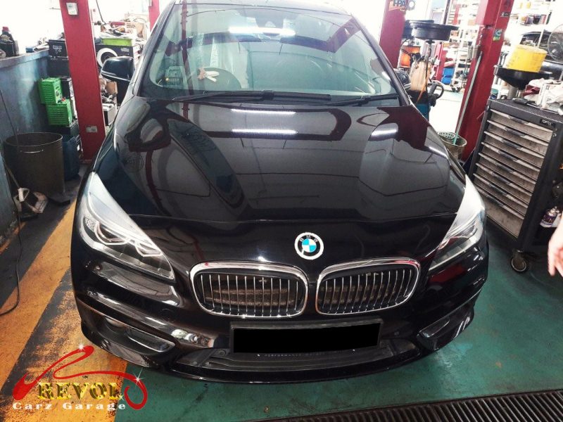 BMW 216i parked at the workshop, in for front shock absorber inspection.